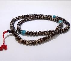 Mala de hueso oscuro grabado con pedrería